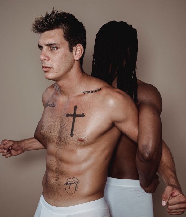 Man performing a controlled strength exercise in a bright, minimalist gym.